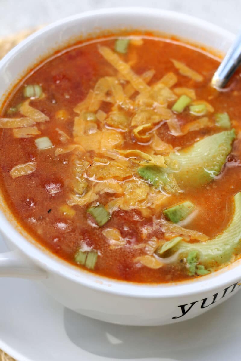 California Pizza Kitchen's Sedona Tortilla Soup--a flavorful soup inspired by the restaurant made with tomatoes, corn, jalapeño, garlic and tortilla chips that cook right into the broth, with optional chicken for extra protein.