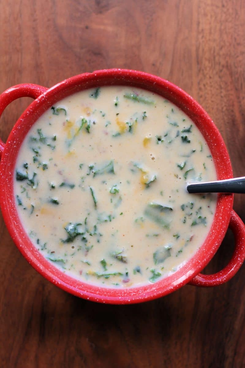 Cheddar Garlic Herb Potato Soup--an easy Instant Pot or slow cooker soup made with red potatoes, garlic, herbs, heavy cream, cheddar cheese and kale for a homey dinner.