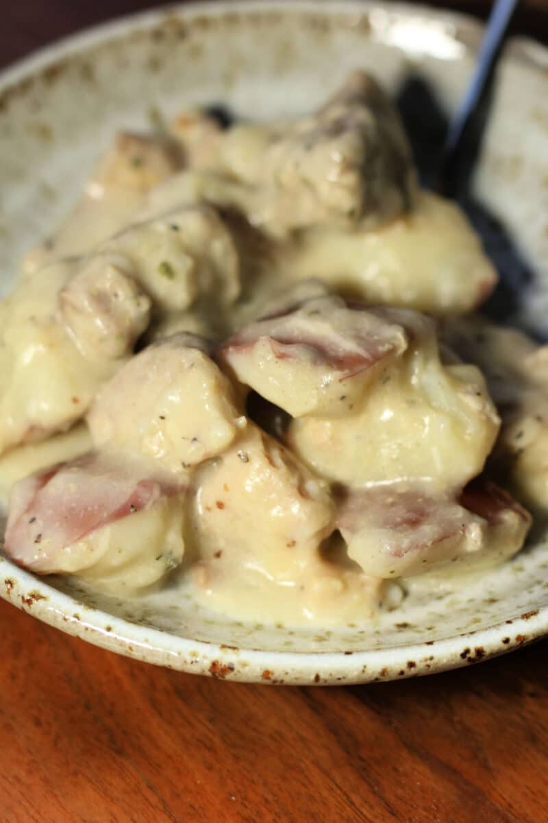 Creamy Garlic Parmesan Chicken and Potatoes--an easy Instant Pot or slow cooker dinner made with tender chicken thighs, red potatoes, plenty of garlic and a creamy lemon Parmesan sauce.