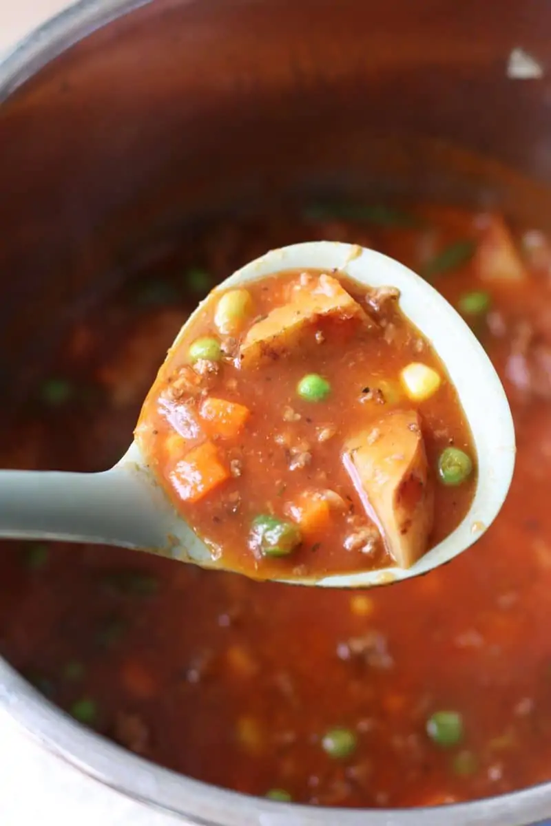 Crock Pot Vegetable Beef Soup--this cozy soup has tender potatoes, mixed vegetables, tomatoes and savory ground beef and can be made in the Instant Pot or slow cooker.