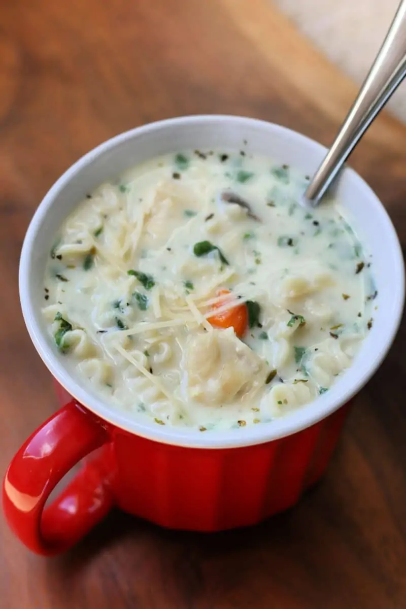 Decadent Creamy Alfredo Lasagna Soup--an Instant Pot soup made with tender chicken, lasagna noodles, carrots, mushrooms and spinach in a creamy garlic parmesan broth.