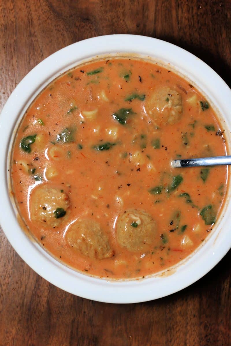 Slow Cooker Cheesy Meatball Soup--a cozy soup made with Italian meatballs, ditalini pasta, tomatoes, spinach, Parmesan and a creamy tomato broth.
