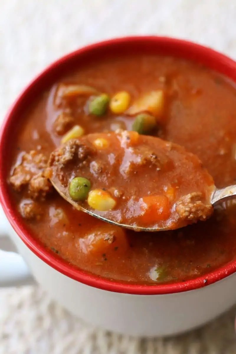 Crock Pot Vegetable Beef Soup--this cozy soup has tender potatoes, mixed vegetables, tomatoes and savory ground beef and can be made in the Instant Pot or slow cooker.