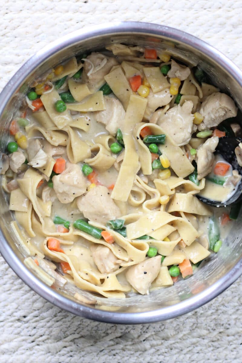 Creamy Chicken Pot Pie Pasta--an easy Instant Pot dinner with tender chicken thighs, wide egg noodles, mushrooms and vegetables in a creamy, savory sauce.