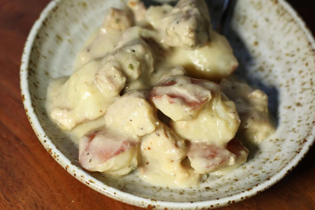 Creamy Garlic Parmesan Chicken and Potatoes--an easy Instant Pot or slow cooker dinner made with tender chicken thighs, red potatoes, plenty of garlic and a creamy lemon Parmesan sauce.