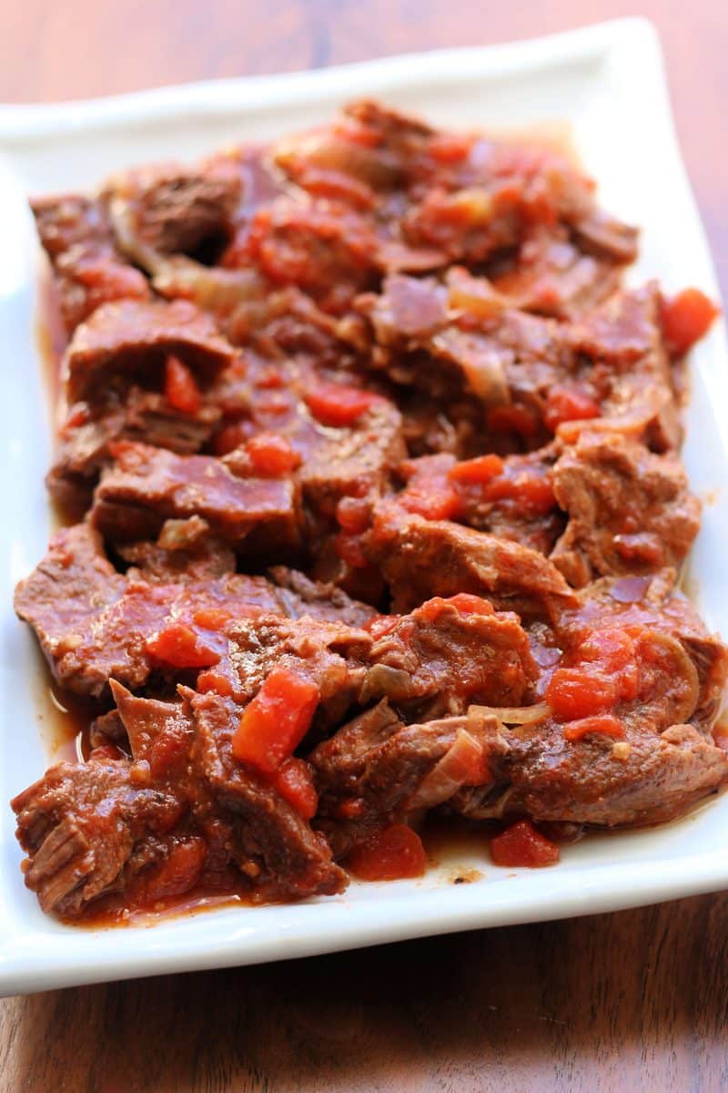 Tennessee Barbeque Beef--tender chuck steak, onions, tomatoes and smoky seasonings are slow cooked until the beef is fall-apart tender. Perfect served over mashed potatoes, noodles or rice.