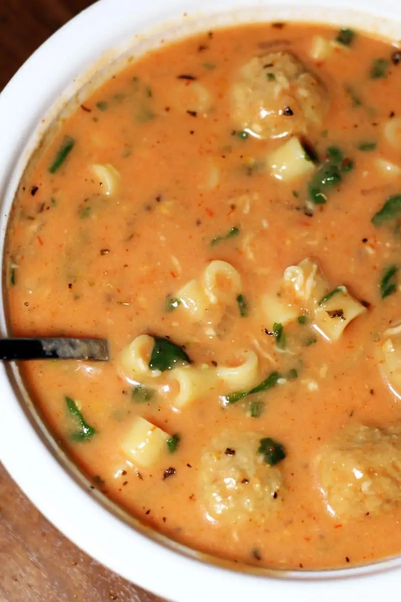 Slow Cooker Cheesy Meatball Soup--a cozy soup made with Italian meatballs, ditalini pasta, tomatoes, spinach, Parmesan and a creamy tomato broth.