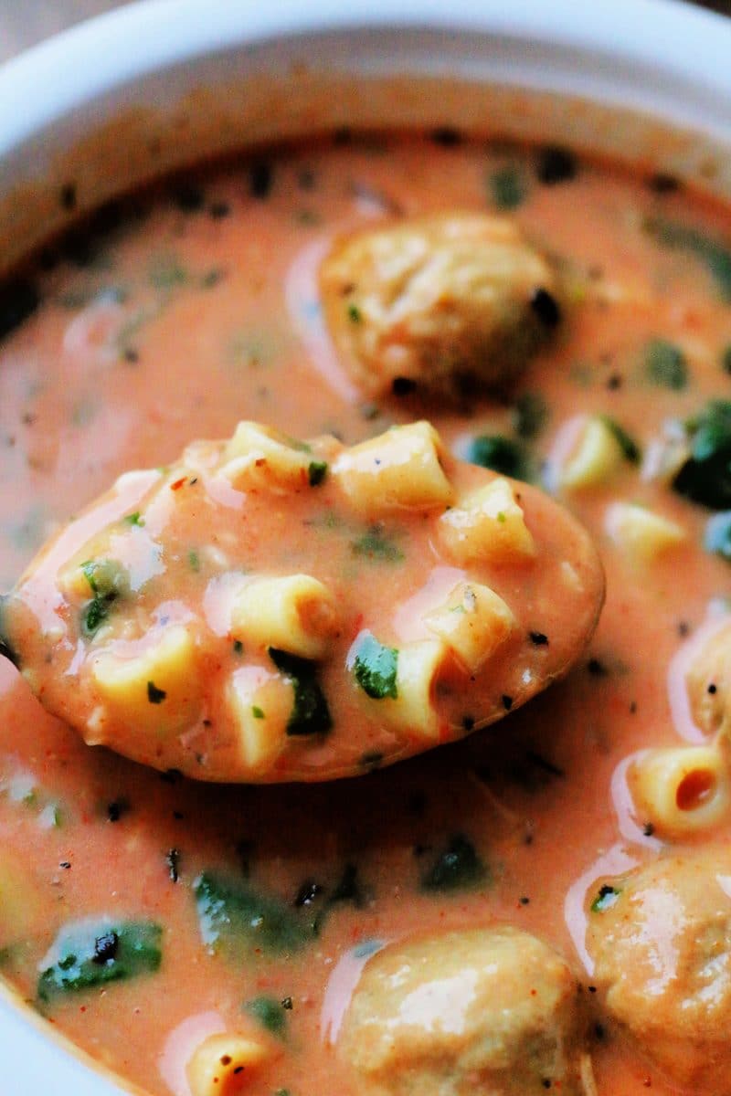 Slow Cooker Cheesy Meatball Soup--a cozy soup made with Italian meatballs, ditalini pasta, tomatoes, spinach, Parmesan and a creamy tomato broth.