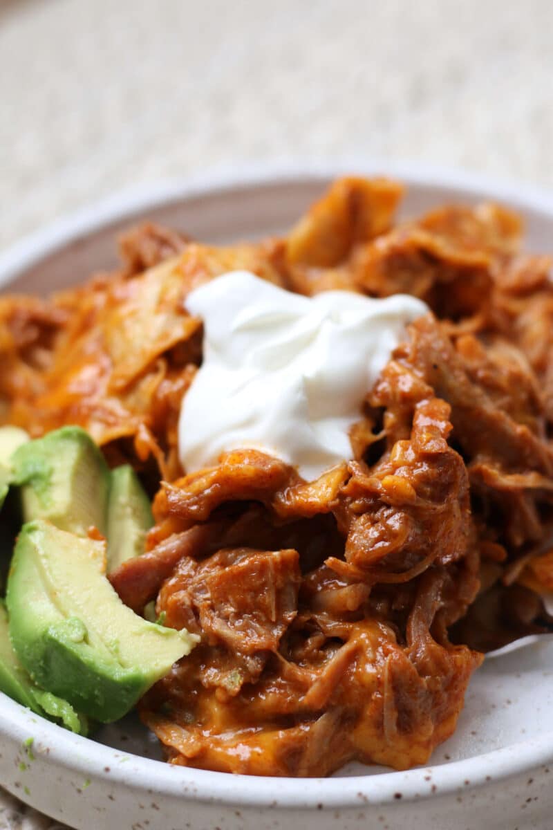An easy 4-ingredient dinner with tender shredded pork, enchilada sauce, soft tortillas and melty cheese.