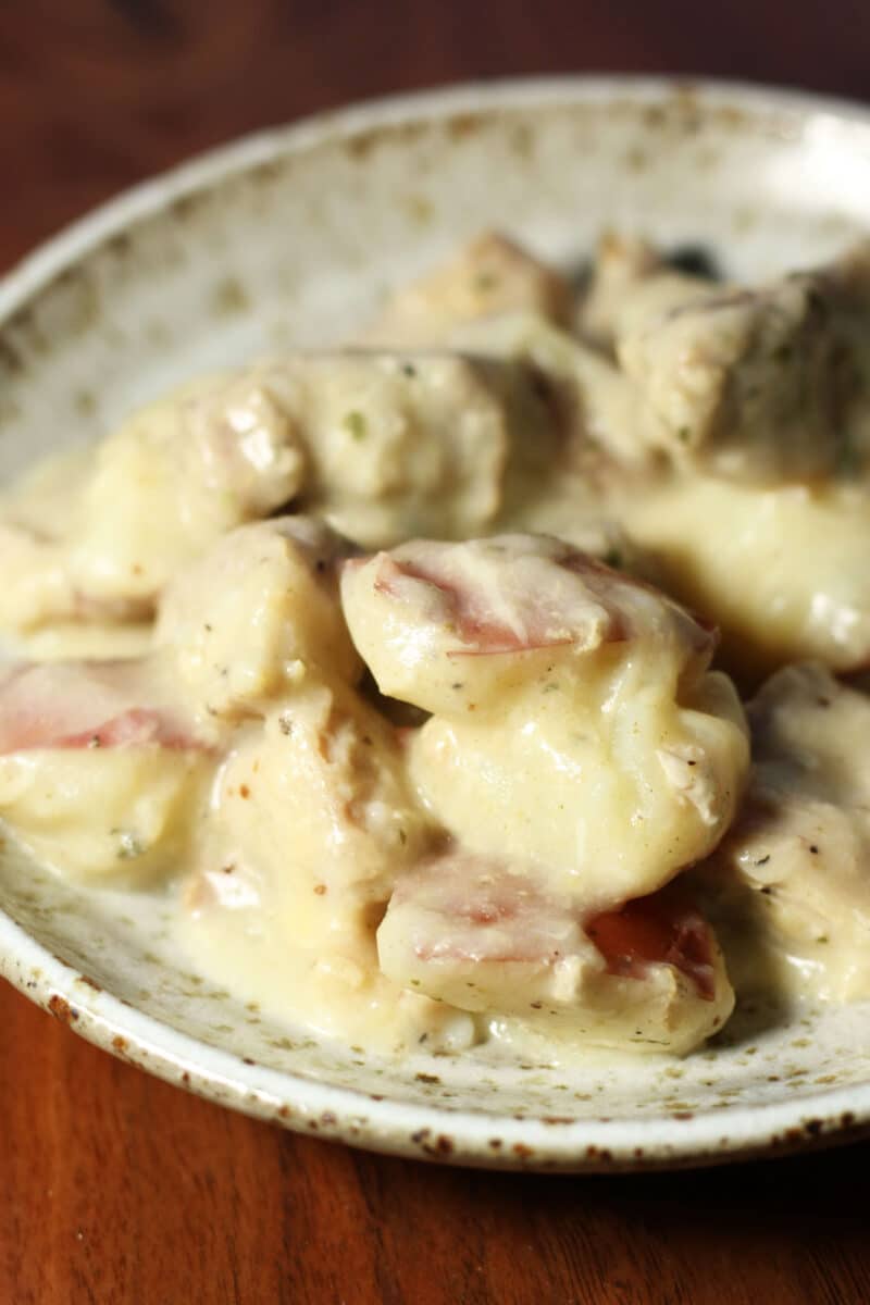 Creamy Garlic Parmesan Chicken and Potatoes--an easy Instant Pot or slow cooker dinner made with tender chicken thighs, red potatoes, plenty of garlic and a creamy lemon Parmesan sauce.