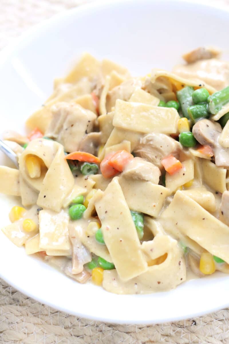 Creamy Chicken Pot Pie Pasta--an easy Instant Pot dinner with tender chicken thighs, wide egg noodles, mushrooms and vegetables in a creamy, savory sauce.