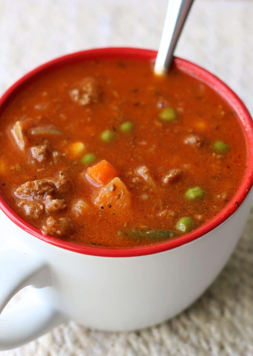 Crock Pot Vegetable Beef Soup--this cozy soup has tender potatoes, mixed vegetables, tomatoes and savory ground beef and can be made in the Instant Pot or slow cooker.