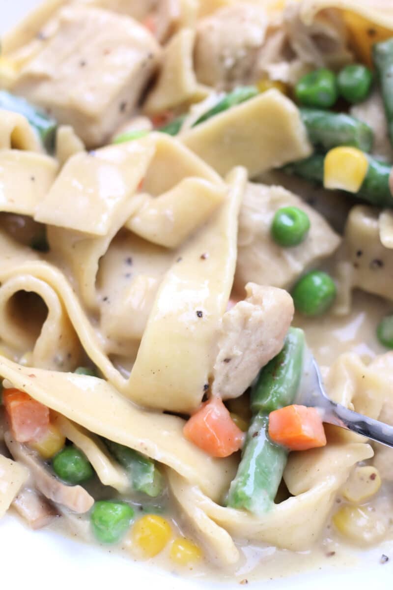 Creamy Chicken Pot Pie Pasta--an easy Instant Pot dinner with tender chicken thighs, wide egg noodles, mushrooms and vegetables in a creamy, savory sauce.