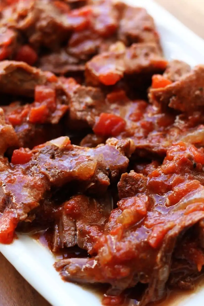 Tennessee Barbeque Beef--tender chuck steak, onions, tomatoes and smoky seasonings are slow cooked until the beef is fall-apart tender. Perfect served over mashed potatoes, noodles or rice.