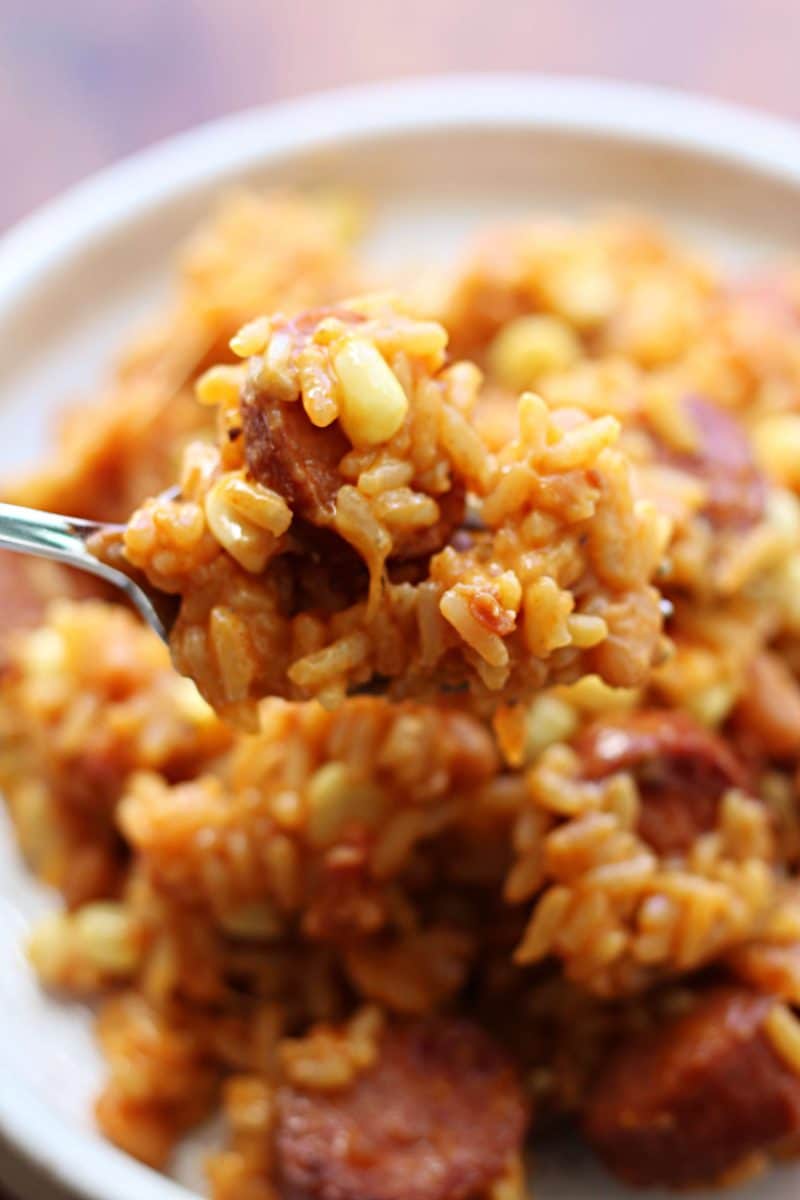 Homestyle Cowboy Beef & Rice Heaven--an Instant Pot dinner made with smoky sausage, pork and beans, corn, bacon and cheddar cheese for an easy meal packed with savory flavor.