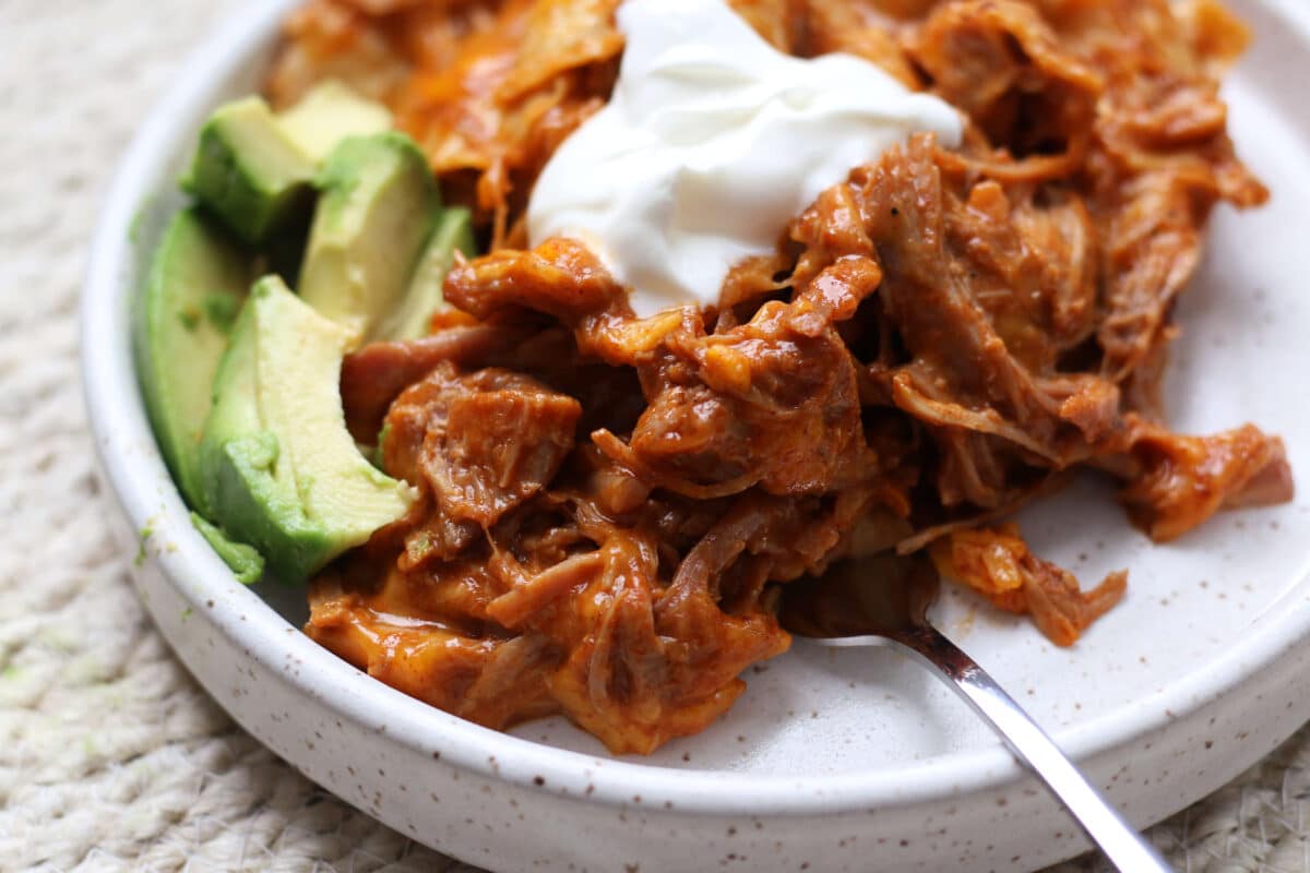 An easy 4-ingredient dinner with tender shredded pork, enchilada sauce, soft tortillas and melty cheese.