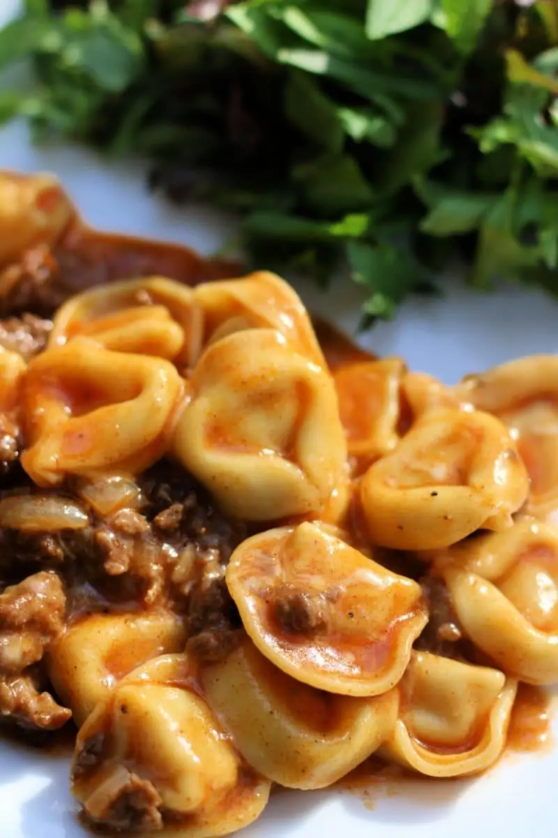 Cheesy Beef Enchilada Tortellini--an easy dinner made with ground beef, cheese tortellini, red enchilada sauce and melty cheese, make it in the slow cooker or Instant Pot.