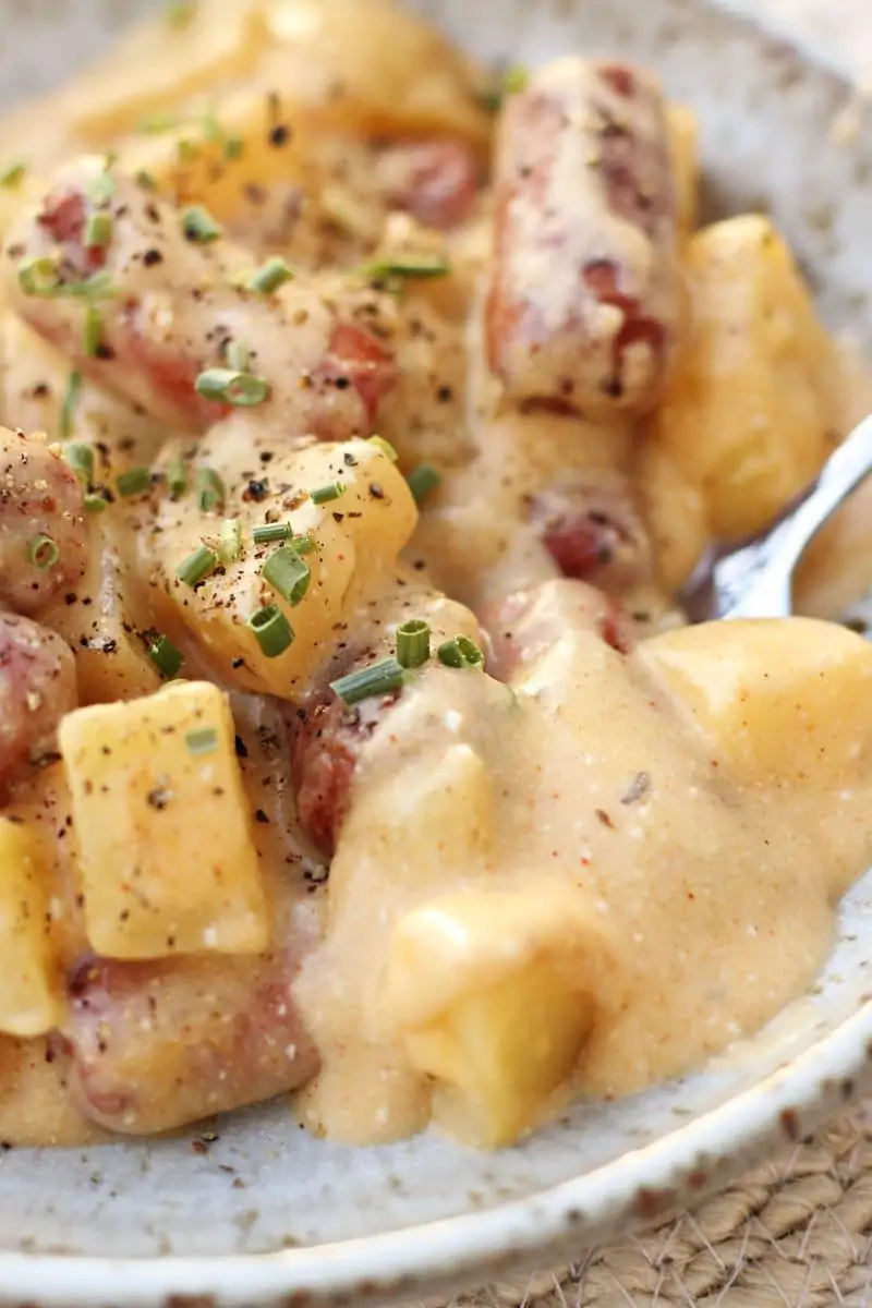 Crock Pot Little Smokies and Cheesy Potato Casserole--an easy crockpot dinner made with tender Yukon gold potatoes, smoky sausages, Cajun seasoning and a creamy, cheesy sauce.