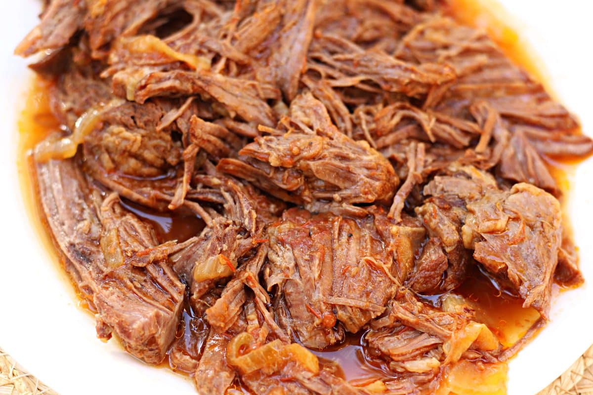 A tender, fall-apart beef chuck roast cooked with onions, crushed tomatoes and a savory beef broth. Make it in the Instant Pot or slow cooker!