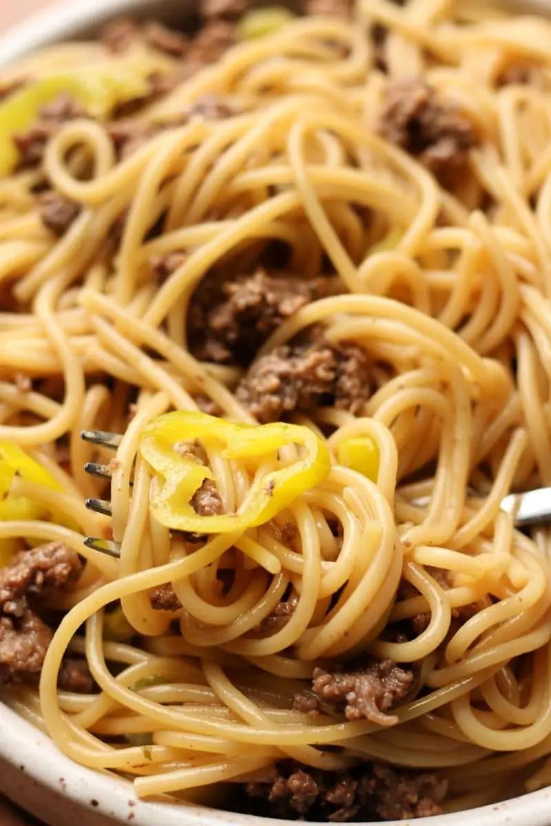 Mississippi Ground Beef Spaghetti--an easy Instant Pot dinner made with ground beef, spaghetti, ranch seasoning, au jus gravy mix, butter and tangy pepperoncinis for a flavorful twist on traditional spaghetti.