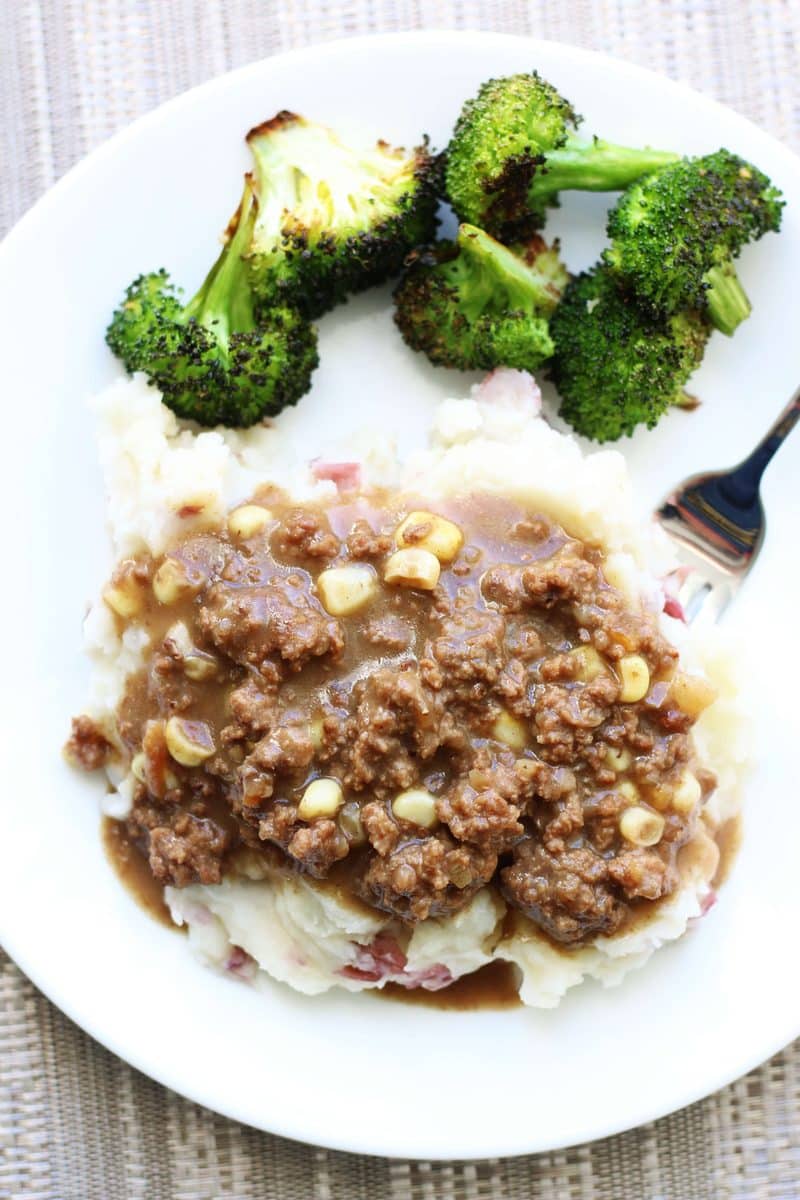 Southern Hamburger Onion Gravy Casserole--an easy dinner made with seasoned ground beef, corn and a savory onion gravy served over creamy homemade mashed potatoes, all cooked in one pot!