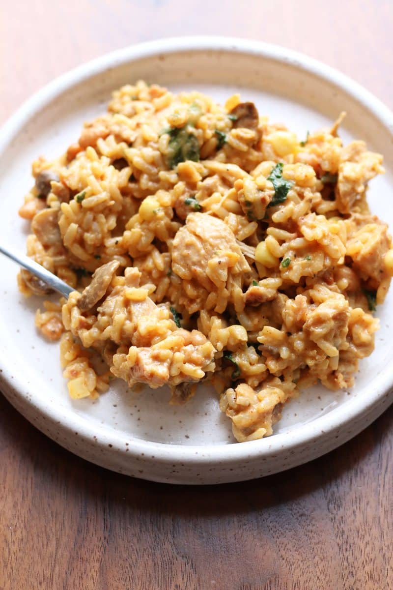 An easy Instant Pot dinner made with tender chicken, rice, beans, corn, mushrooms, bacon and cheddar cheese all mixed together in a creamy, flavorful sauce.