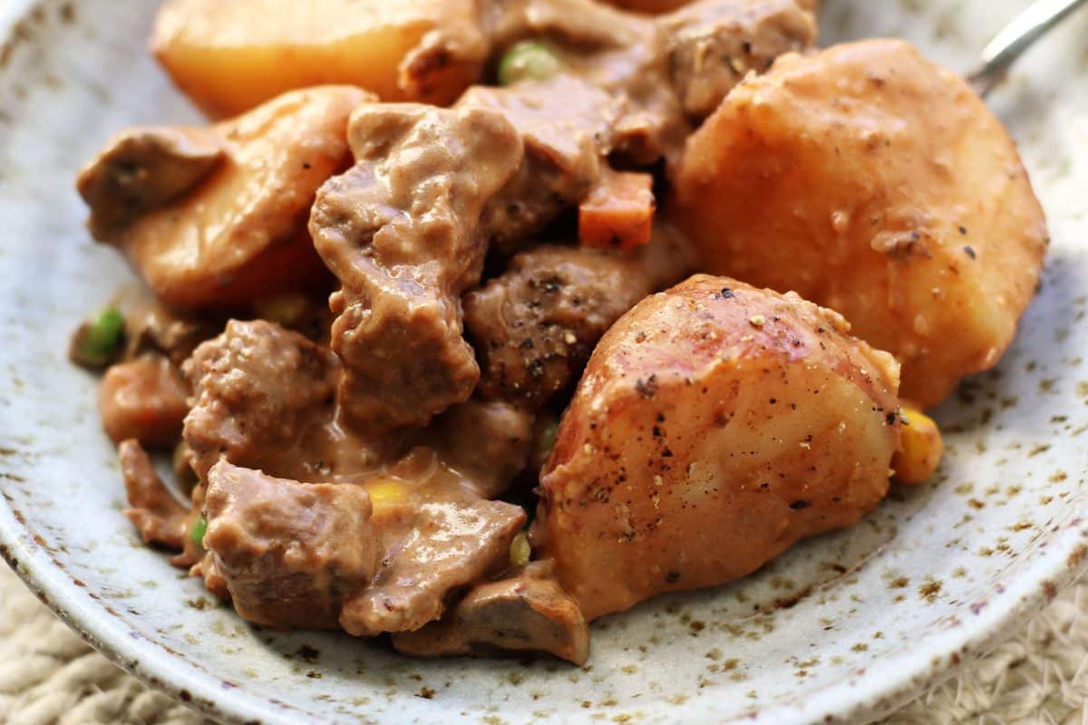 Slow Cooked Steak Diane Casserole--an easy crockpot dinner made with tender beef, red potatoes and mushrooms in a rich gravy that's finished off with a splash of cream.