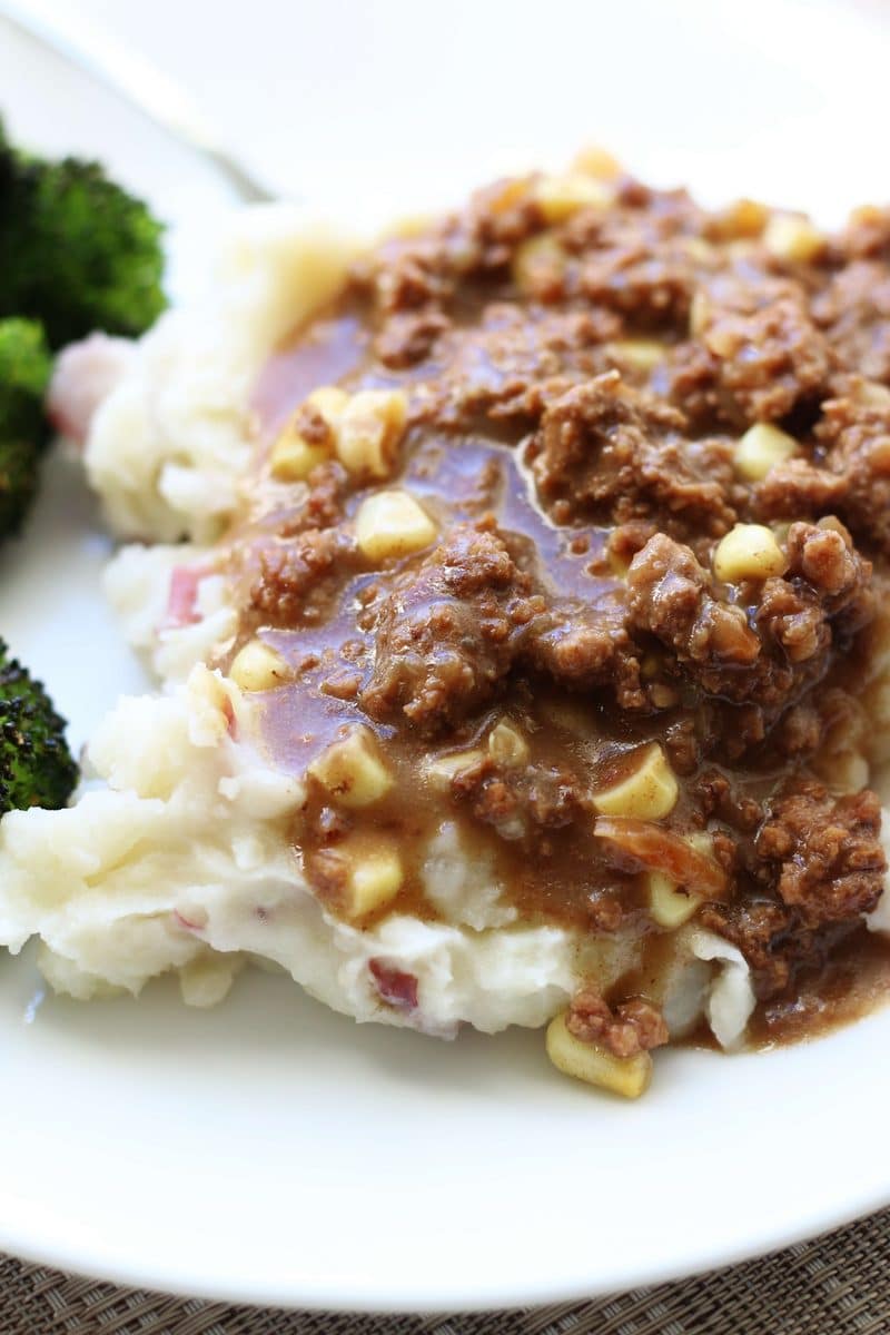 Southern Hamburger Onion Gravy Casserole--an easy dinner made with seasoned ground beef, corn and a savory onion gravy served over creamy homemade mashed potatoes, all cooked in one pot!