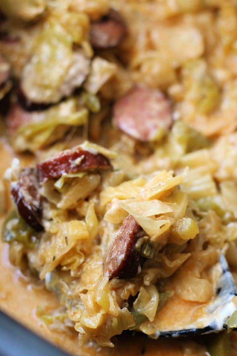 Creamy Cheesy Dirty Cabbage Casserole--a flavorful dinner made with smoked sausage, tender cabbage, bell peppers and Cajun seasoning, with creamy, cheesy finish. Make it in the Crockpot or Instant Pot!