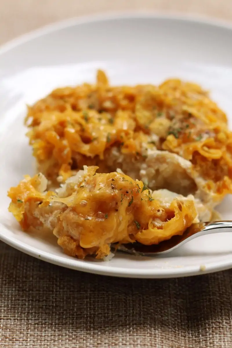 An easy side dish made with frozen tater tots, cream of mushroom soup, sour cream and cheddar cheese, topped with buttery, crunchy cornflakes. Make it in the oven or slow cooker!