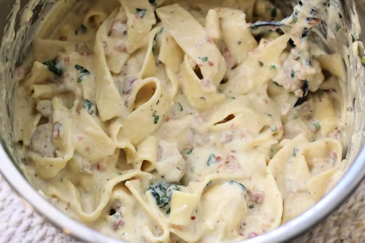 The Crazy Amazingly Good Casserole--an easy Instant Pot dinner made with tender chicken, wide noodles, bacon, ranch seasoning, spinach and a creamy parmesan sauce.