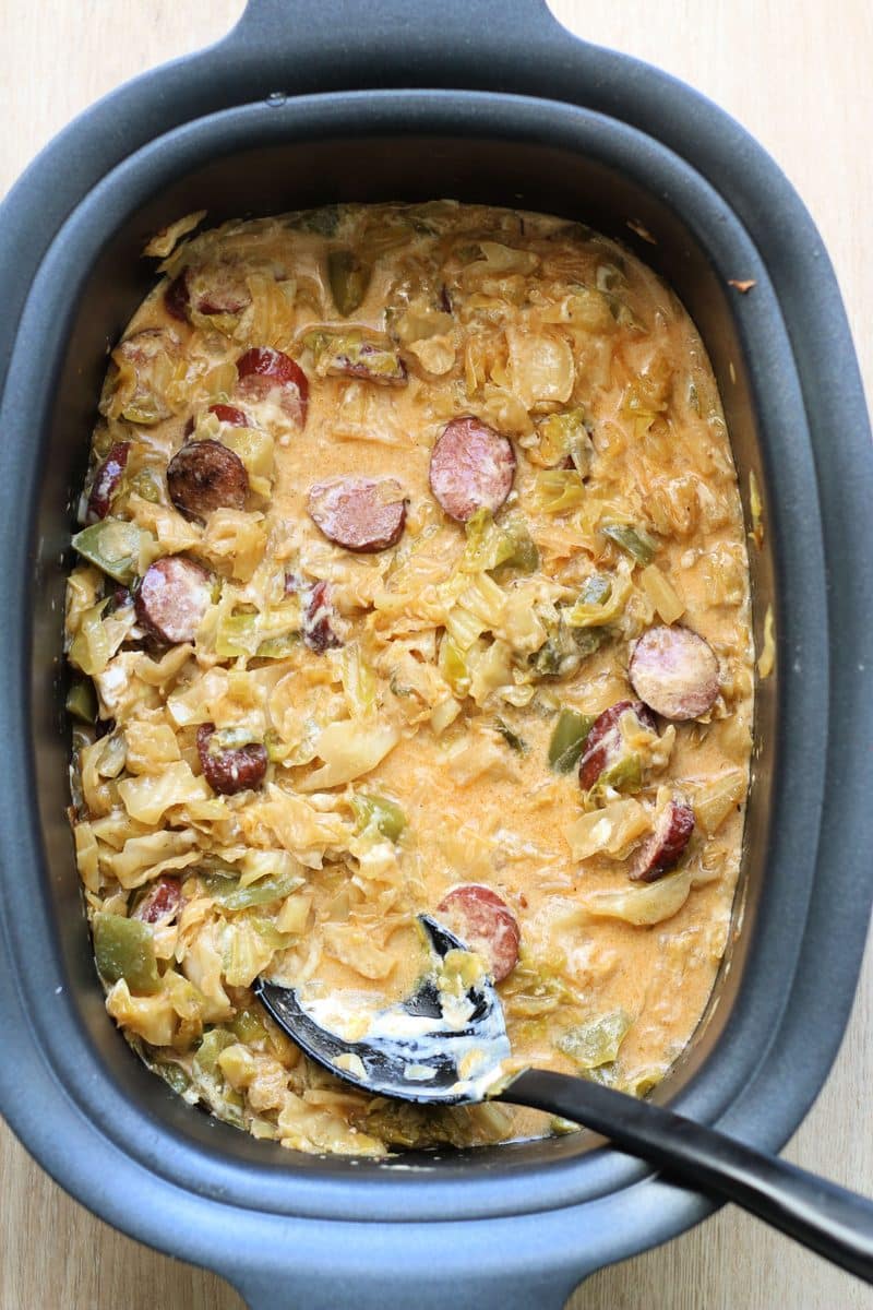 Creamy Cheesy Dirty Cabbage Casserole--a flavorful dinner made with smoked sausage, tender cabbage, bell peppers and Cajun seasoning, with creamy, cheesy finish. Make it in the Crockpot or Instant Pot!