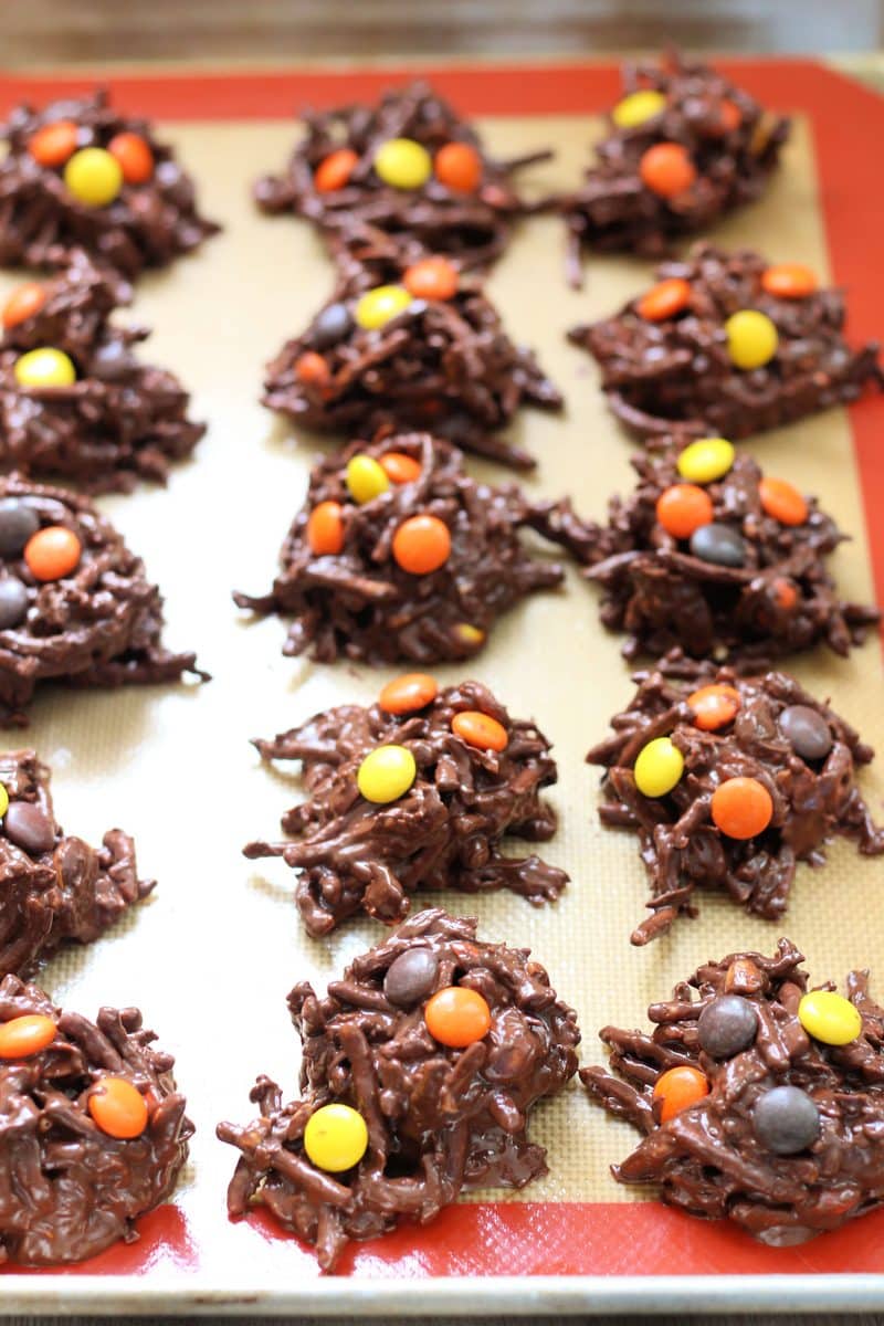 Crock Pot Halloween Haystacks--an easy no-bake Halloween treat made with crunchy peanut butter, melted chocolate, crispy chow mein noodles, coconut and colorful Reese's Pieces candies.