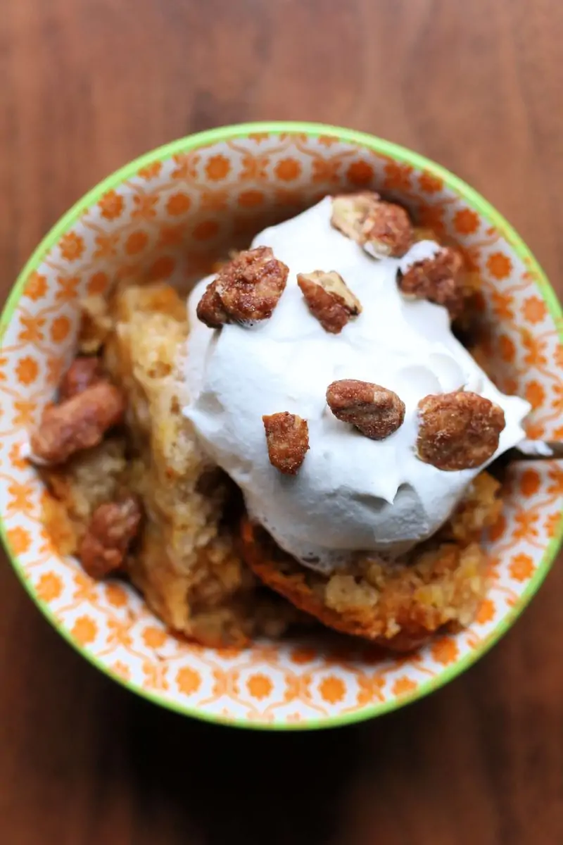 Pumpkin Cobbler--an easy fall dessert made with creamy pumpkin filling, buttery yellow cake mix topping and pecans, cooked in the slow cooker and served warm with vanilla ice cream or whipped cream.