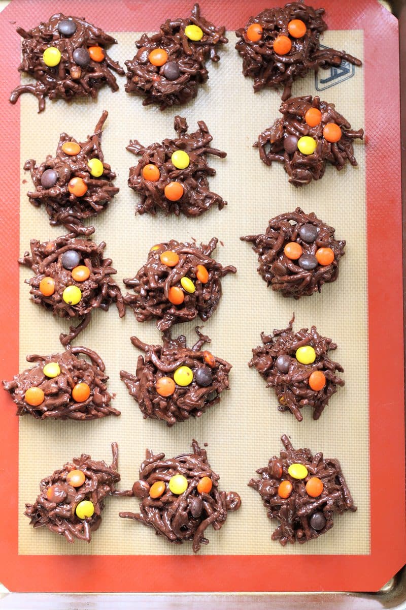 Crock Pot Halloween Haystacks--an easy no-bake Halloween treat made with crunchy peanut butter, melted chocolate, crispy chow mein noodles, coconut and colorful Reese's Pieces candies.
