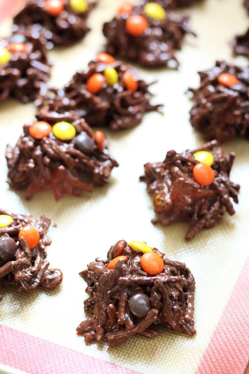 Crock Pot Halloween Haystacks--an easy no-bake Halloween treat made with crunchy peanut butter, melted chocolate, crispy chow mein noodles, coconut and colorful Reese's Pieces candies.