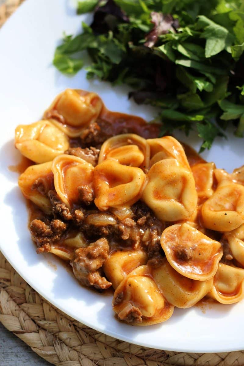 Cheesy Beef Enchilada Tortellini--an easy dinner made with ground beef, cheese tortellini, red enchilada sauce and melty cheese, make it in the slow cooker or Instant Pot.