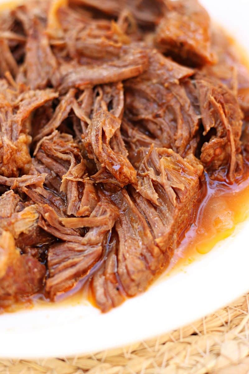 A tender, fall-apart beef chuck roast cooked with onions, crushed tomatoes and a savory beef broth. Make it in the Instant Pot or slow cooker!