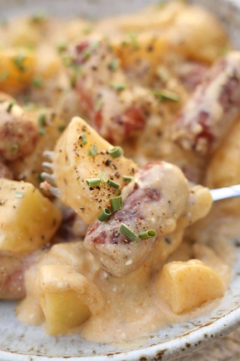 Crock Pot Little Smokies and Cheesy Potato Casserole--an easy crockpot dinner made with tender Yukon gold potatoes, smoky sausages, Cajun seasoning and a creamy, cheesy sauce.