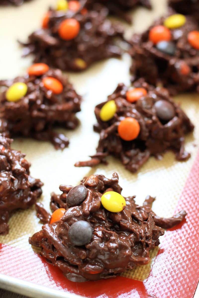 Crock Pot Halloween Haystacks--an easy no-bake Halloween treat made with crunchy peanut butter, melted chocolate, crispy chow mein noodles, coconut and colorful Reese's Pieces candies.