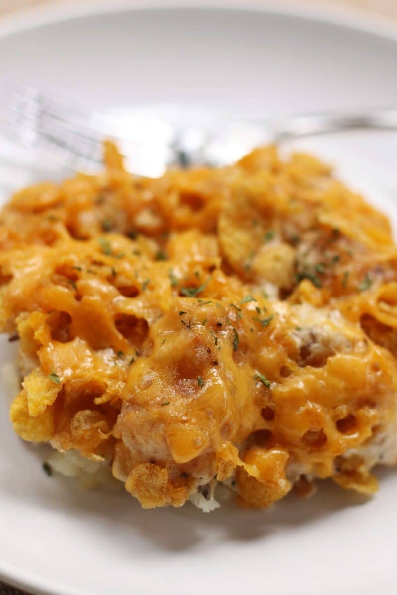 An easy side dish made with frozen tater tots, cream of mushroom soup, sour cream and cheddar cheese, topped with buttery, crunchy cornflakes. Make it in the oven or slow cooker!
