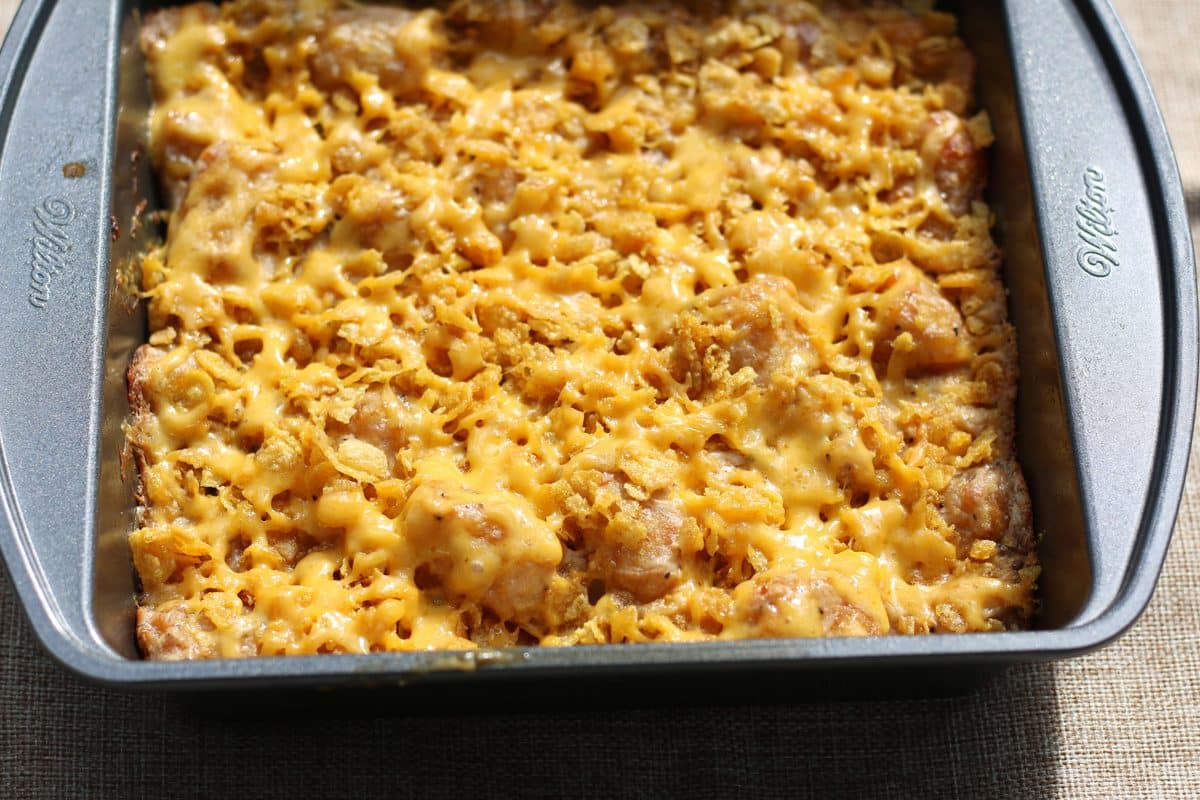 An easy side dish made with frozen tater tots, cream of mushroom soup, sour cream and cheddar cheese, topped with buttery, crunchy cornflakes. Make it in the oven or slow cooker!