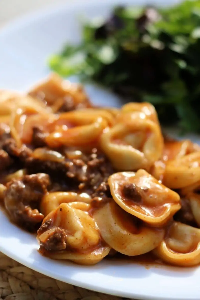 Cheesy Beef Enchilada Tortellini--an easy dinner made with ground beef, cheese tortellini, red enchilada sauce and melty cheese, make it in the slow cooker or Instant Pot.